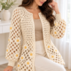 Cream crochet cardigan with open lattice mesh pattern and butter yellow daisy appliques on sleeves and body