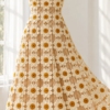 Ivory crochet daisy midi dress with ochre centers displayed on a white mannequin in soft natural light
