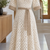 Ivory crochet midi dress with windowpane lattice pattern displayed on a white mannequin featuring square neckline and sand colored belt