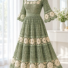 Sage green crochet lace dress with square neckline, bell sleeves, and ivory sunburst rosettes displayed on white mannequin